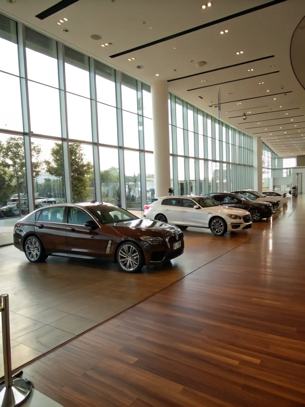 A high-end car dealership showcasing a variety of imported vehicles, emphasizing luxury and innovation in the vehicle import sector.